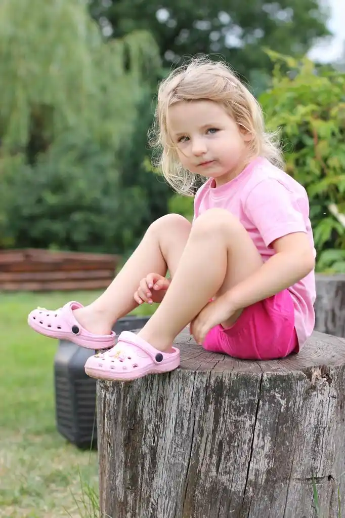 白人女孩,坐在一个树桩上的白人女孩
