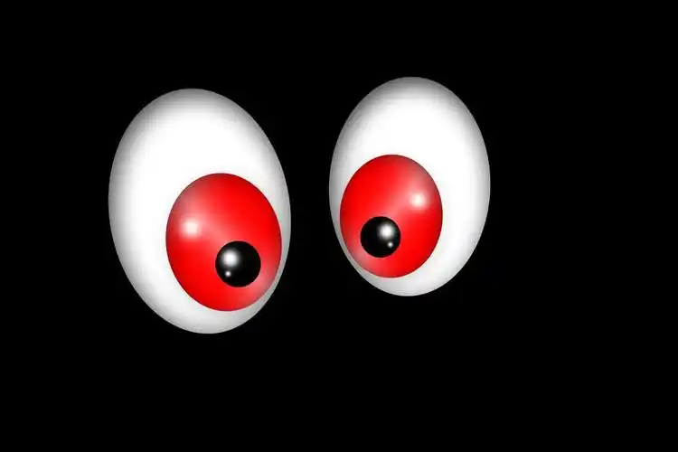 在黑暗中的眼睛,与现场两个木偶眼睛在黑色的背景图