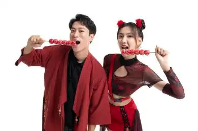 快乐的年轻情侣吃糖葫芦