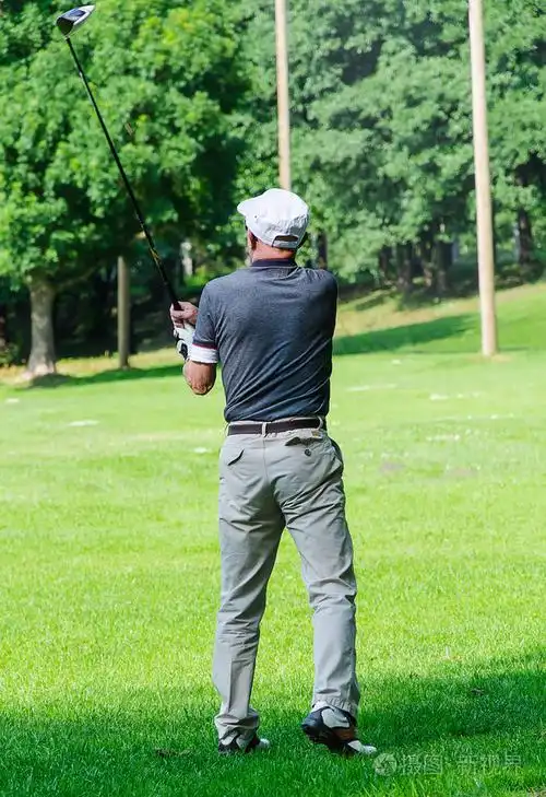 男人打高尔夫户外的后视图